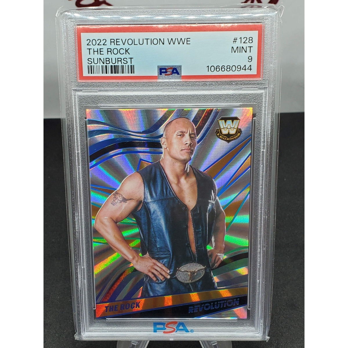 2022 Panini Revolution WWE The Rock Card WWE Sunburst #128 Low Pop PSA 9 #/99
