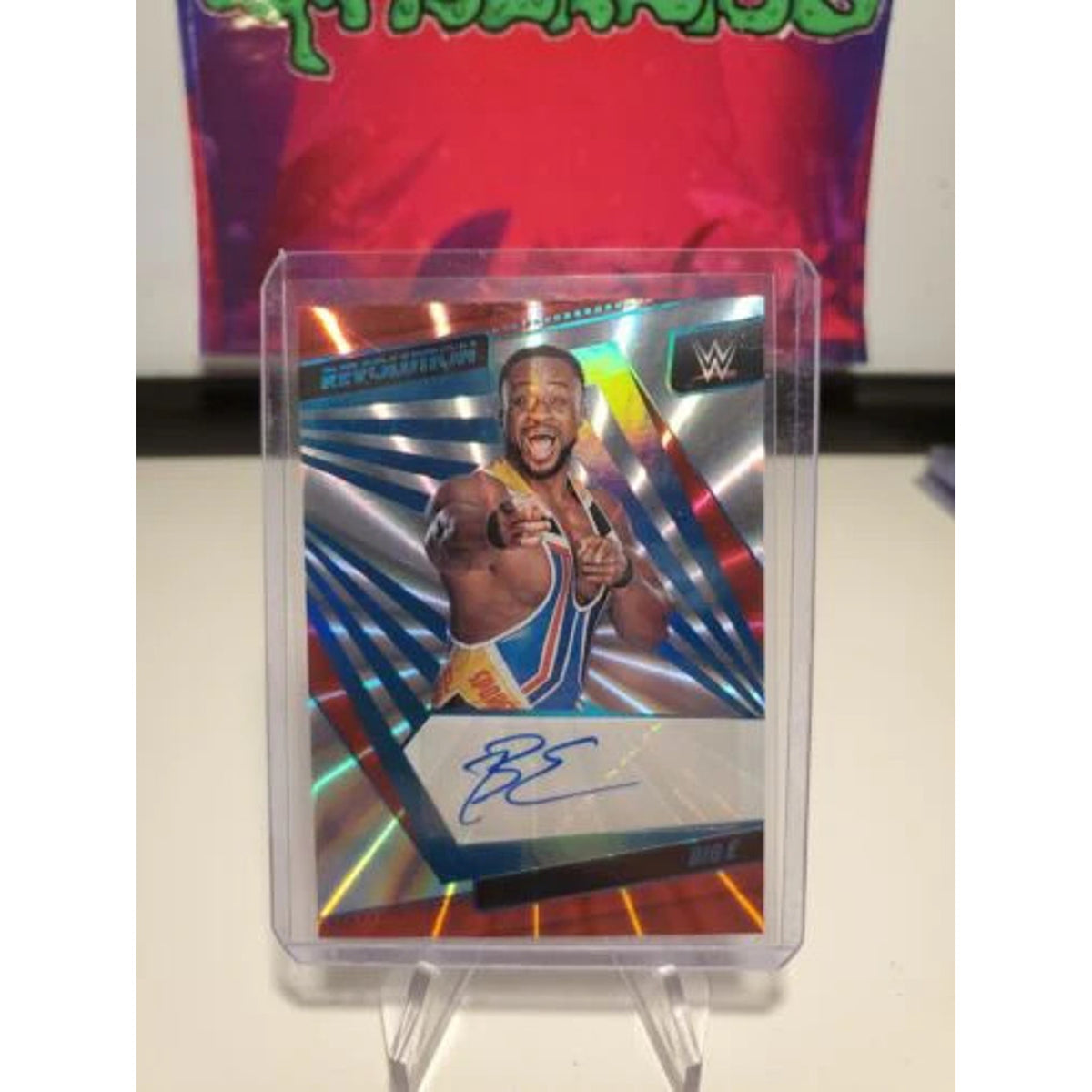 BIG E - 2022 PANINI REVOLUTION WWE SUNBURST AUTO #81/99 NEWDAY