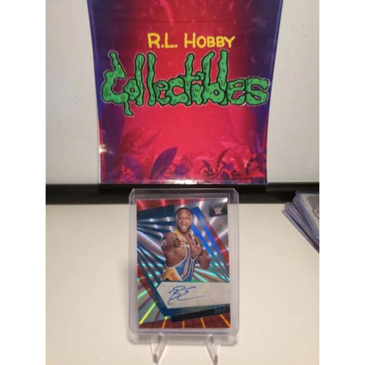 BIG E - 2022 PANINI REVOLUTION WWE SUNBURST AUTO #81/99 NEWDAY